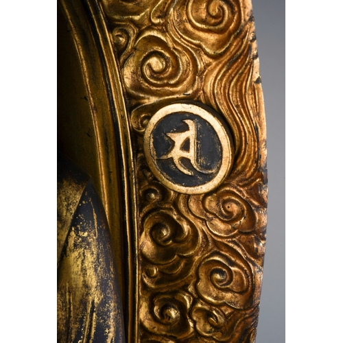 132 - An Edo period (1615-1868) lacquered giltwood figure of Amida Nyorai, glass urna, both hands in raigo... 