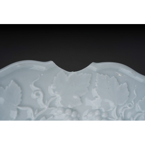 137 - A Meissen porcelain blanc de chine relief moulded plate, wavy rim, decorated with fruiting vine, cro... 