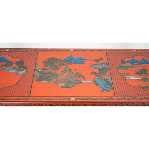 141 - A Chinese red lacquer carved altar table with a pierced frieze, the top decorated with mountainous l... 