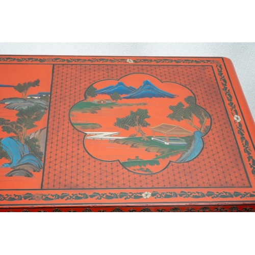 141 - A Chinese red lacquer carved altar table with a pierced frieze, the top decorated with mountainous l... 