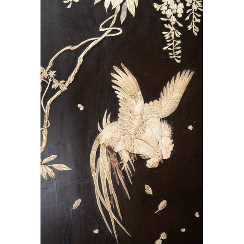 143 - A Japanese Meiji period shibayama two fold screen, fret tops above lacquer panels with applied carve... 