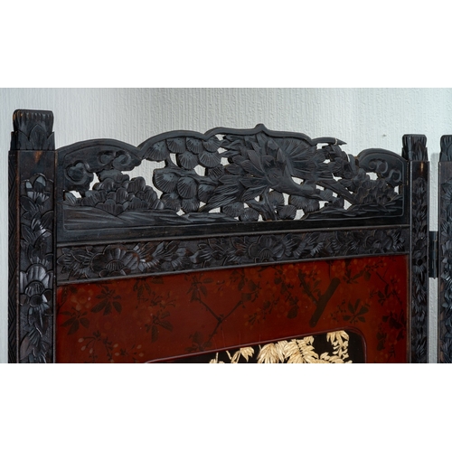 143 - A Japanese Meiji period shibayama two fold screen, fret tops above lacquer panels with applied carve... 