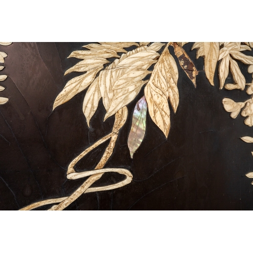 143 - A Japanese Meiji period shibayama two fold screen, fret tops above lacquer panels with applied carve... 
