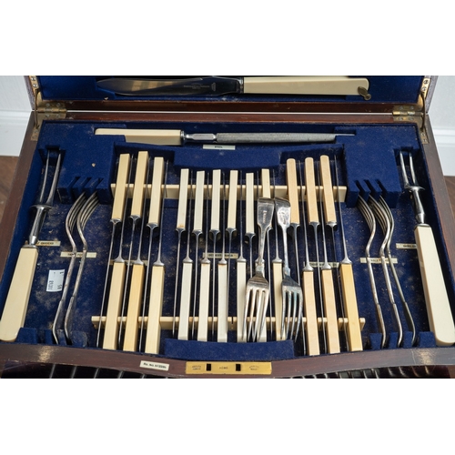 144 - An Edwardian  mahogany and satinwood banded serpentine fronted table canteen of silver plated Fiddle... 