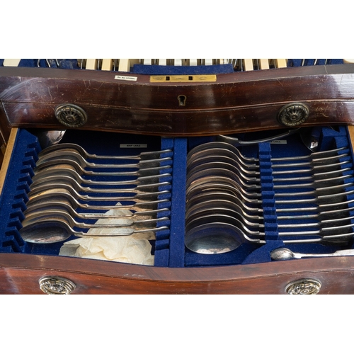 144 - An Edwardian  mahogany and satinwood banded serpentine fronted table canteen of silver plated Fiddle... 