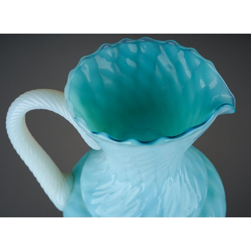 146 - An Italian blue and vaseline glass ewer, lattice and swirl decoration, rope twist handle, the stem m... 
