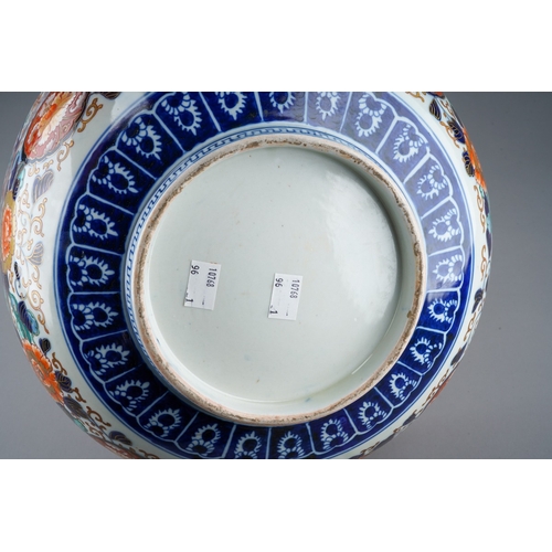 155 - A Japanese porcelain Imari punch bowl, the bowl interior painted with geisha and another figure in a... 