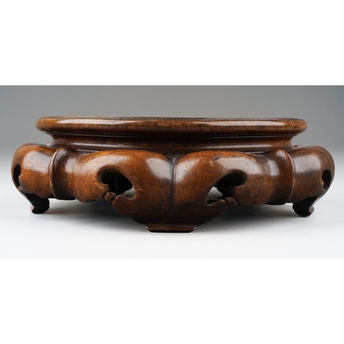 156 - A Chinese hardwood stand of cirular form, carved with lobed and pierced base with four feet, inner d... 