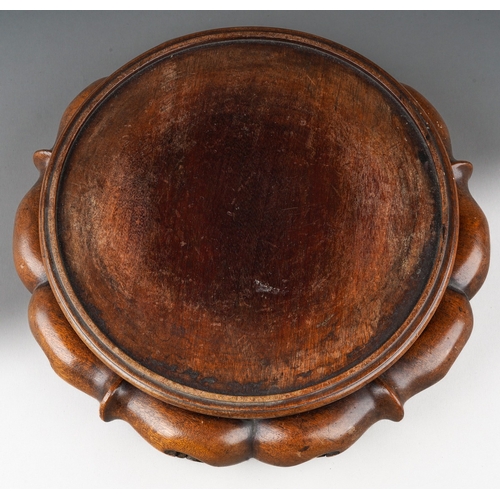 156 - A Chinese hardwood stand of cirular form, carved with lobed and pierced base with four feet, inner d... 