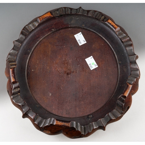 156 - A Chinese hardwood stand of cirular form, carved with lobed and pierced base with four feet, inner d... 