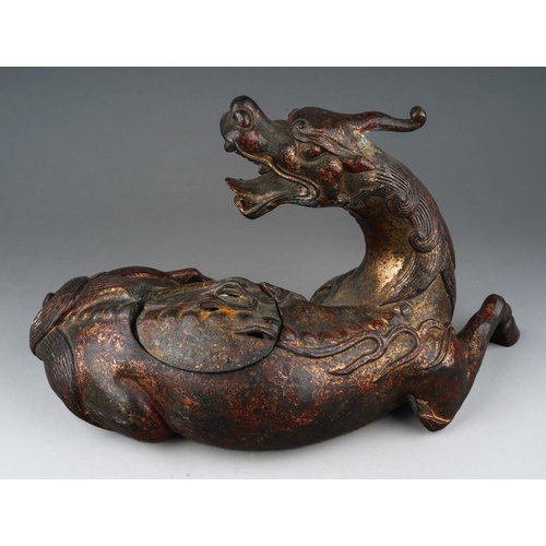 162 - A Japanese cast bronze koro in the form of a reclining Kirin, pierced cover, unsigned, height 16cm x... 