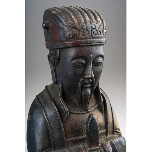 163 - A Chinese bronze figure of a seated official, worn gilding, height 24cm