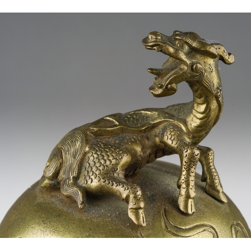 165 - A Japanese Meiji period (1868-1912) gilt bronze koro with cover on stand, with mythical beast to dom... 