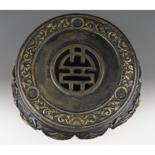 166 - A Chinese bronze stand, the top cast with a band of shallow relief scrolls and foliate decoration, t... 
