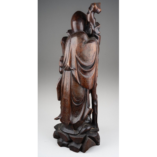 167 - A Chinese carved hardwood figure of a elder with a staff and holding a child , silver wire inlay, ca... 
