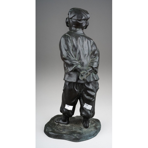 168 - A 20th century Japanese cast bronze figure of a man holding his hands behind his back, standing on a... 