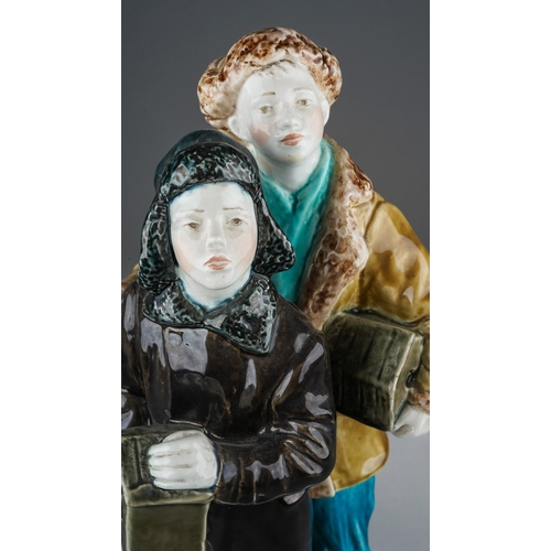 170 - A 20th century Russian figure group of two boys dressed in Winter clothes, carrying bird boxes and w... 