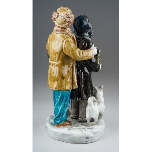170 - A 20th century Russian figure group of two boys dressed in Winter clothes, carrying bird boxes and w... 