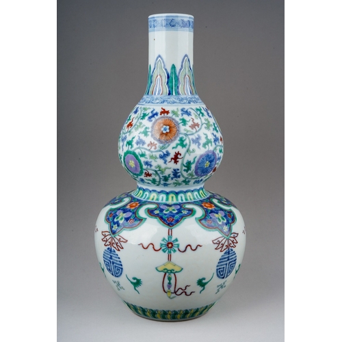 171 - A Chinese Doucai porcelain double gourd vase, decorated with alternating hanging Shou symbols and ta... 