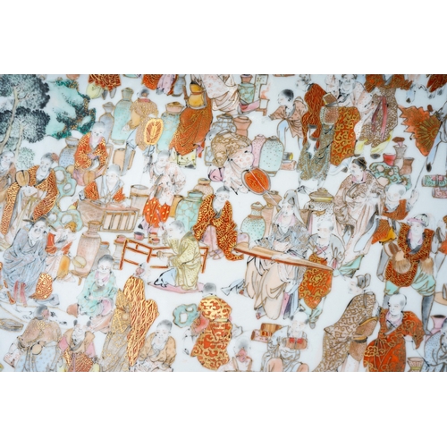 174 - A Japanese Kutani porcelain charger, the shaped square panel to centre painted with a crowd of artis... 