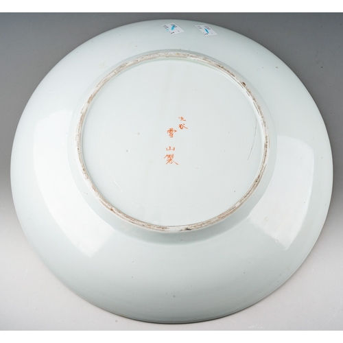 174 - A Japanese Kutani porcelain charger, the shaped square panel to centre painted with a crowd of artis... 