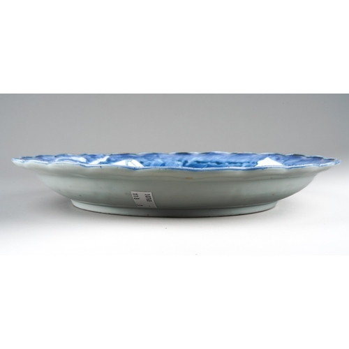 177 - A Japanese Arita porcelain blue and white scallop edged plate, possibly late 17th century, decorated... 