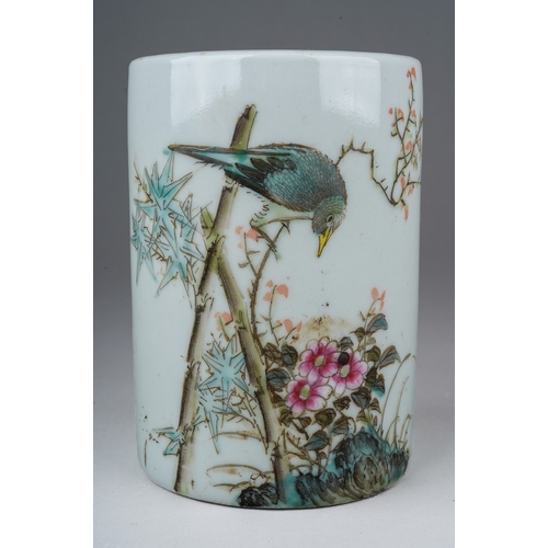 203 - A 20th century Chinese porcelain brush pot of cylindrical form, painted with a bird in a flowering b... 