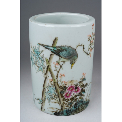 203 - A 20th century Chinese porcelain brush pot of cylindrical form, painted with a bird in a flowering b... 