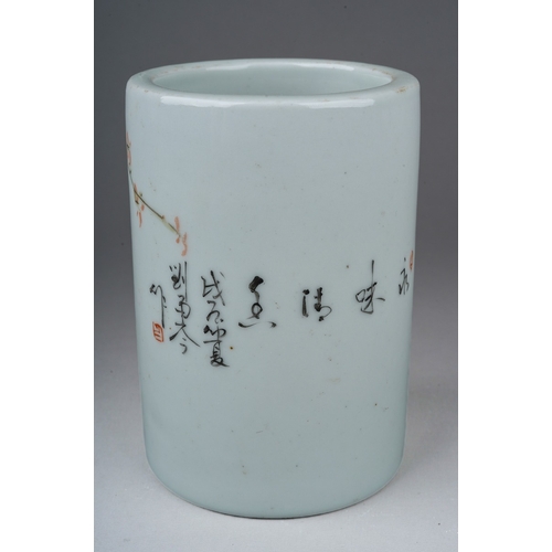 203 - A 20th century Chinese porcelain brush pot of cylindrical form, painted with a bird in a flowering b... 