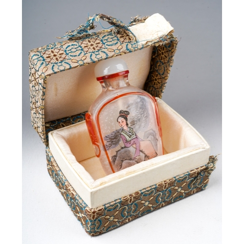 205 - A 20th century Chinese glass snuff bottle, reverse painted with a seated female and a bird on a rock... 