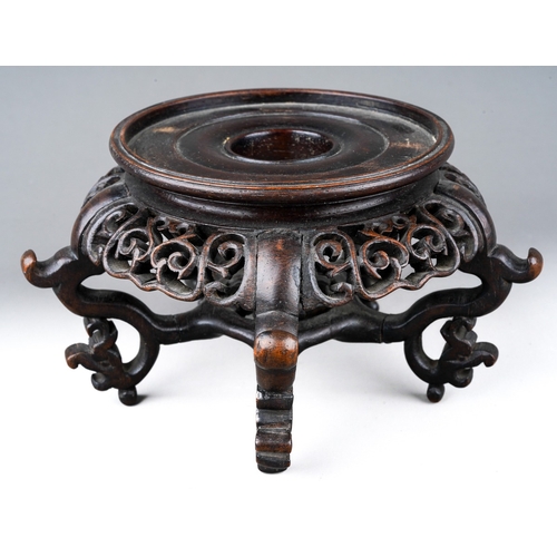 207 - A small Chinese carved and pierced hardwood stand, on five ornately scrolled legs linked by a pierce... 