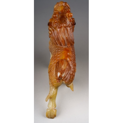 211 - A Chinese jadeite Foo dog carved as walking, length 21cm x height 14.5cm