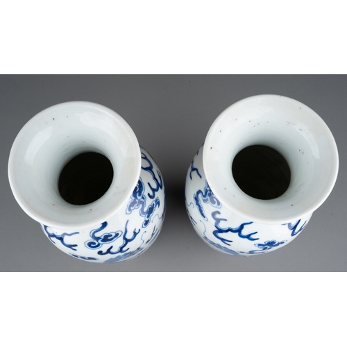 219 - A pair of Chinese porcelain blue and white baluster vases, each decorated with two five clawed drago... 