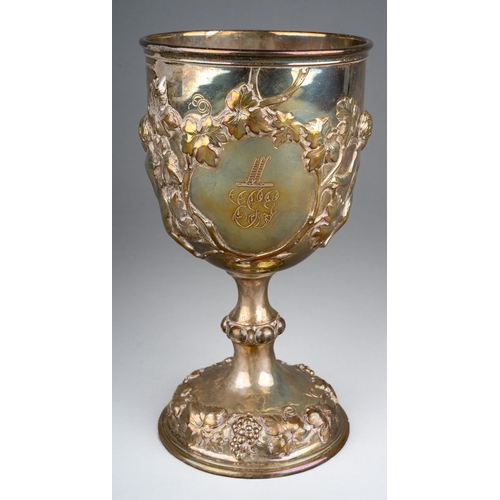 A Victorian silver goblet, the bowl repousse decorated and chased  with  three putto amongst fruiting vine and a cartouche engraved with crest and initials, worn gilt interior, on a knopped pedestal with further fruiting vine, maker Robert Hennell III, London 1863, 11.2ozt, 348.3 grams, height 18cm