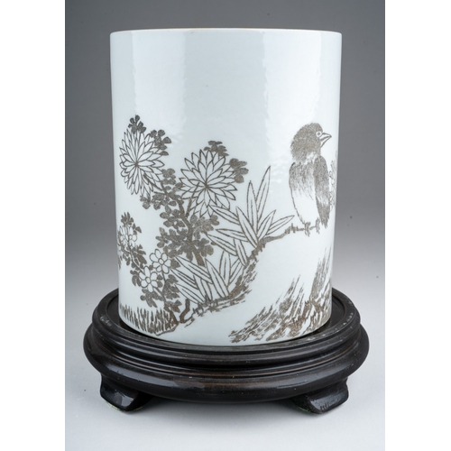 235 - A 20th century Chinese porcelain brush pot of cylindrical form, the monochrome decoration of a bird ... 