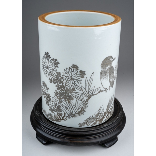 235 - A 20th century Chinese porcelain brush pot of cylindrical form, the monochrome decoration of a bird ... 