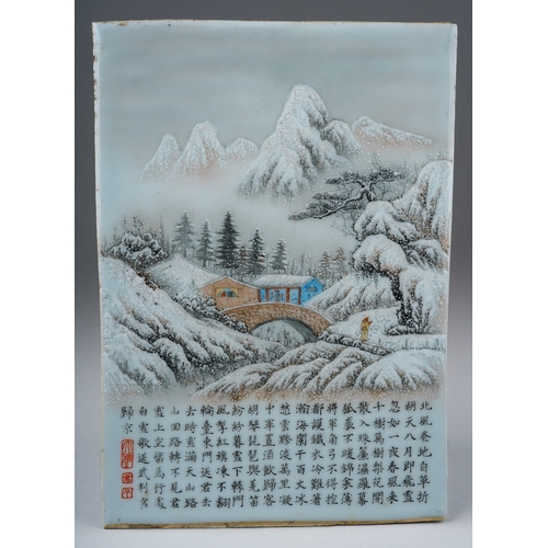 240 - A 20th century Chinese porcelain panel, painted with a snow scene of a figure by a bridge and dwelli... 