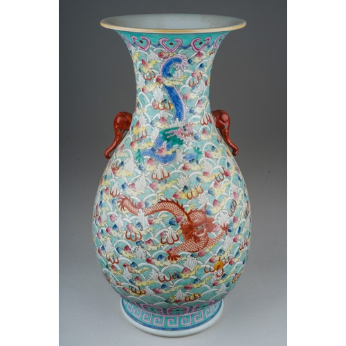 246 - A 20th century Chinese porcelain twin handled baluster vase in the Famille Rose palette, decorated w... 