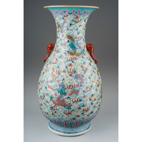 246 - A 20th century Chinese porcelain twin handled baluster vase in the Famille Rose palette, decorated w... 