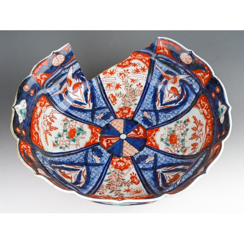 248 - A 19th century Japanese Imari bowl of panelled circular form, wavy rim, four character mark to under... 
