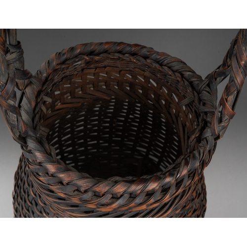 250 - A Japanese woven wicker Ikebana basket with carrying handle, height 46cm x diameter of exterior of n... 