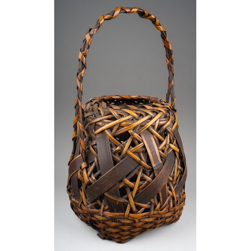 251 - A Japanese woven wicker Ikebana basket with carrying handle, the basket of circular form, height 42c... 