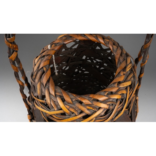 251 - A Japanese woven wicker Ikebana basket with carrying handle, the basket of circular form, height 42c... 