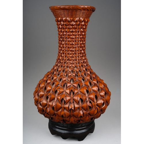 254 - A modern Japanese Ikebana style woven wicker vase with ceramic liner and fitted wooden stand, height... 