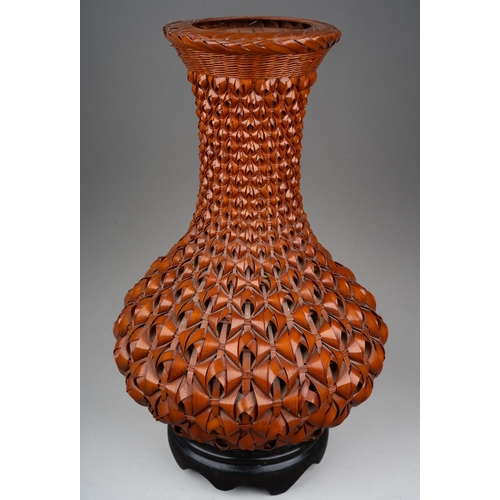 254 - A modern Japanese Ikebana style woven wicker vase with ceramic liner and fitted wooden stand, height... 