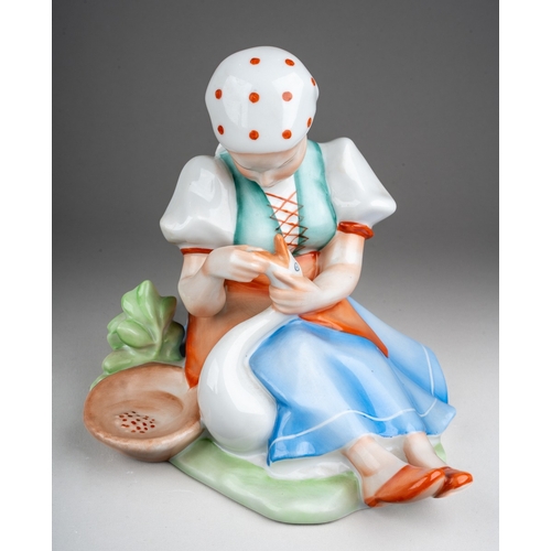 262 - A 20th century Hungarian Zsolnay porcelain figure of a sitting girl holding a duck