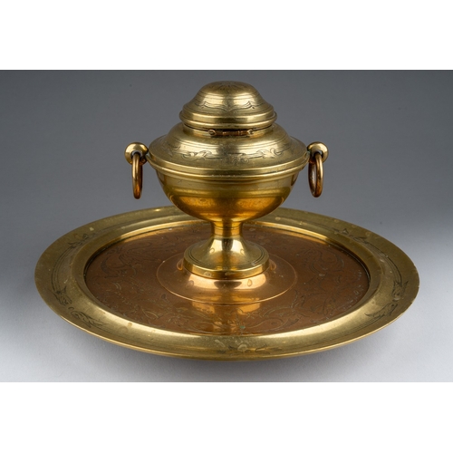 270 - A Charles Asprey brass and copper inkwell, the inkwell of covered urn form, the hinged lid enclosing... 