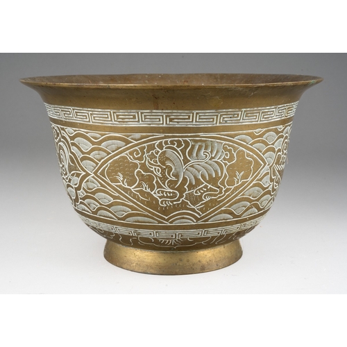 284 - A Chinese brass jardiniere, the exterior decorated with dragons and waves, cast dragon and six chara... 