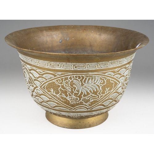 284 - A Chinese brass jardiniere, the exterior decorated with dragons and waves, cast dragon and six chara... 