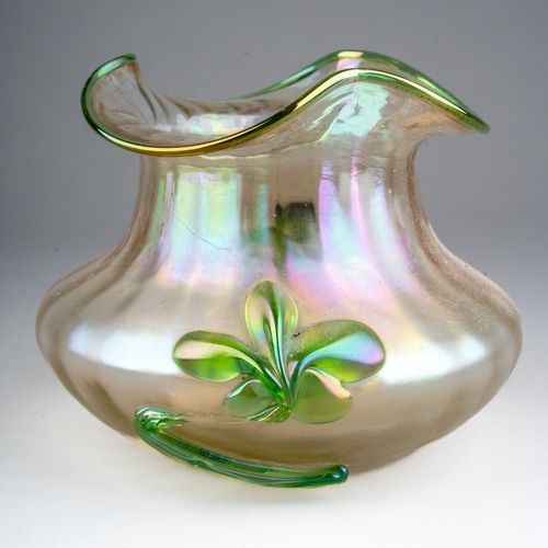 291 - An early 20th century Loetz style iridescent glass vase of squat ribbed form, green rim and applied ... 